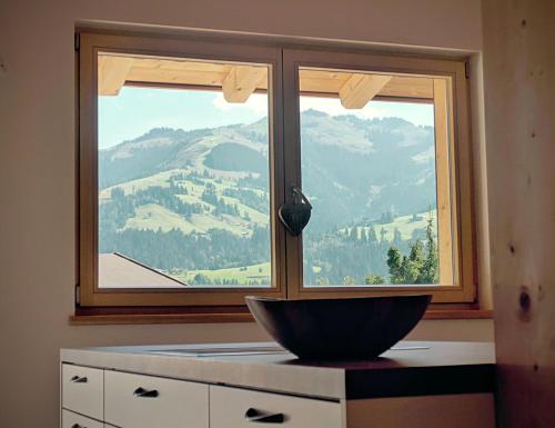 a bowl in front of a window with a view at green Home - Sonniges Chalet in den Alpen in Kirchberg in Tirol