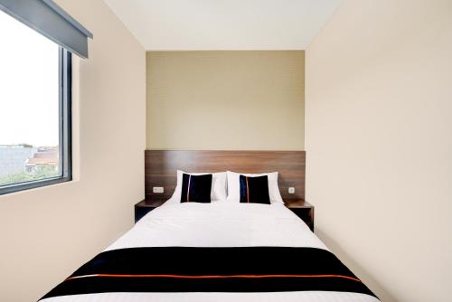 En eller flere senge i et værelse på Townhouse Oak Cengkareng