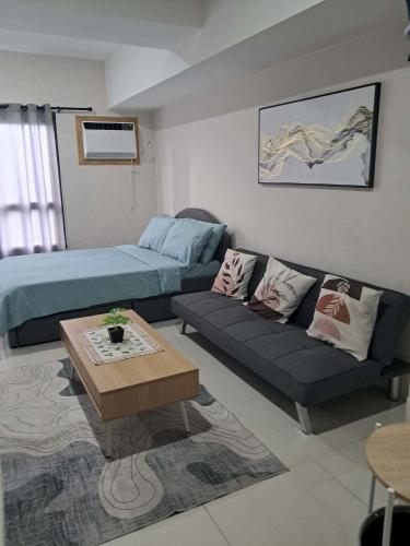 a living room with a couch and a bed at Athenas Cozy Place in Mandaue City