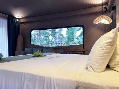 una camera da letto con un letto grande e una TV di Serenity Sands - Island Glamping a Bounty Island