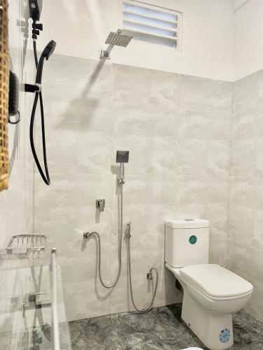 a bathroom with a toilet and a shower in it at Crystal Pearl Villa, Weligama - 3min to beach in Weligama