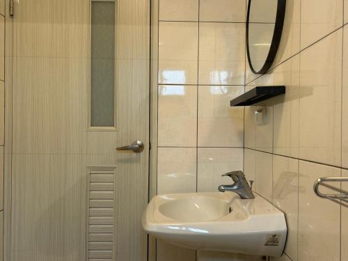 a bathroom with a sink and a mirror at Shower & Sleep in Huxi