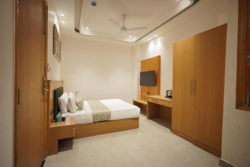 a bedroom with a bed and a television in it at Hotel Northern Heights in Amritsar