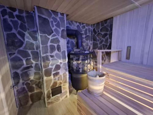 a corner of a room with a stone wall at Під Боржавою in Pilipets