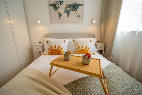 a bedroom with a bed with a table on it at Charming coastal escape in Eastbourne