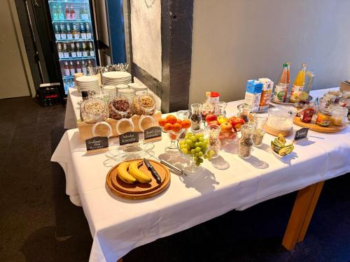 a white table with food and drinks on it at Gästehaus Malgarten in Bramsche