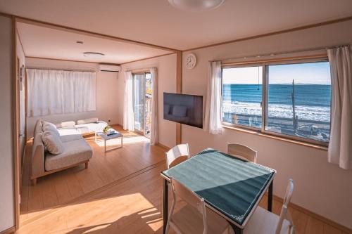 a living room with a view of the ocean at 波音ハウス in Yugawara