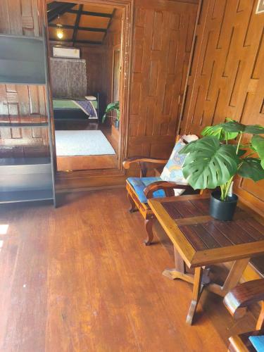 a living room with a table and a couch at Niyang Siam House in Nai Yang Beach