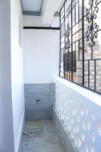 a room with a window and a staircase at Raels home in Mombasa