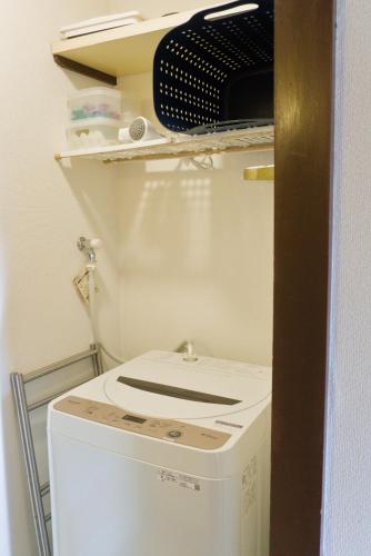 a white washer and dryer in a room at Nishibi in Tokyo