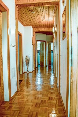 an empty hallway with wood flooring and a room with doors at Ferienwohnung Messner-Schauer in Sankt Kanzian