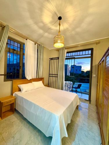 a bedroom with a large bed and a large window at Salmaan Villa in Grand-Baie
