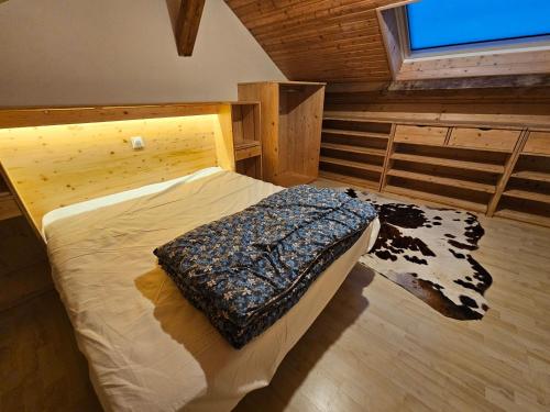 a bedroom with a large bed in a cabin at le flocon chaud in La Bresse