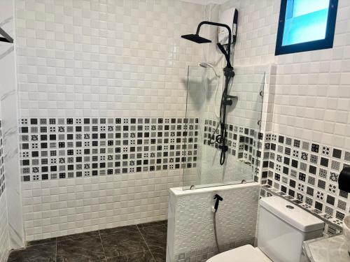 a bathroom with a shower and a toilet in it at Phra Ae Apartments in Ko Lanta