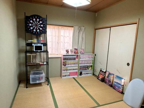 a room with a dart board on the wall at Kawagoe Cinema & Game House for 14 Parking in Kawagoe