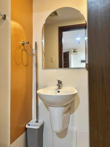 a bathroom with a sink and a mirror at NM 1BR Condo with Balcony at Horizons 101 in Cebu City