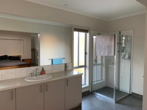a bathroom with a sink and a shower at Large Five Bdrm Home Near Beach in Apollo Bay