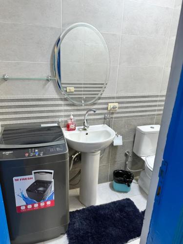 a bathroom with a sink and a toilet and a mirror at Amnesia Residence in Naama Bay - Downtown in Sharm El Sheikh