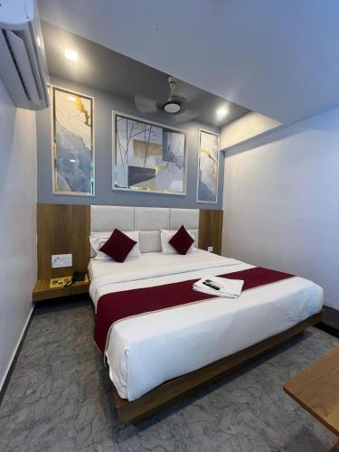 a bedroom with a large bed in a room at Hotel secure inn saroli in Surat