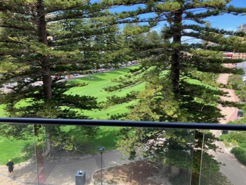 a view from a window of a golf course with trees at The Heart of Glenelg in Glenelg