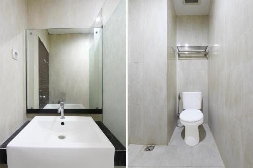 a bathroom with a white sink and a toilet at Collection O near Stadion Manahan formerly Graha Laweyan Solo in Bonorejo