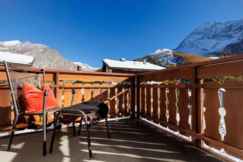 a balcony with a chair and a view of a mountain at Cornelia 1 Ski-In-Out Stunning Views & Sleeps 8 in Saas-Fee