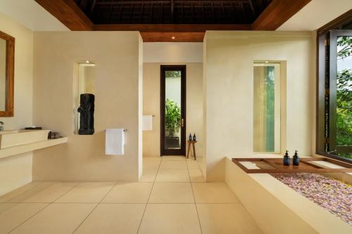a hallway of a home with a table and a window at Villa Leona Ubud in Ubud