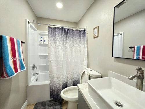 a bathroom with a white toilet and a sink at 8354 Adam Unit B 1Bed 1Bath by SD Stay in Lemon Grove