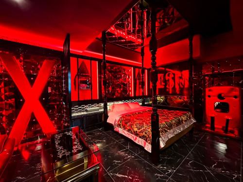 a red room with a bed and a red ceiling at Fire Hotel Nw in Saitama