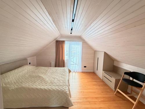 a bedroom with a bed and a large window at Home Hill in Kozevo