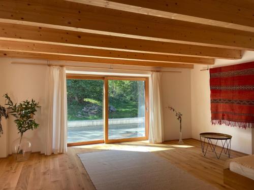 een woonkamer met een groot raam en een tafel bij Alte Mühle Kaisersdorf in Kaisersdorf