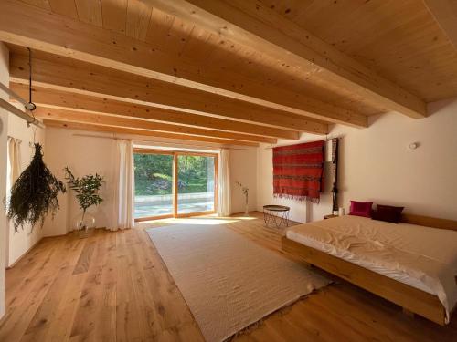 a bedroom with a bed and a large window at Alte Mühle Kaisersdorf in Kaisersdorf