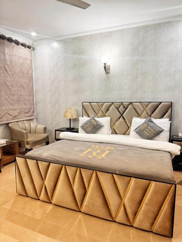 a bedroom with a large bed with a large headboard at Reina Boutique Hotel - G9 in Islamabad
