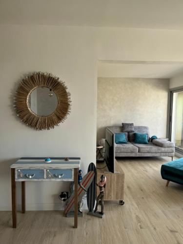 a living room with a couch and a mirror at Sanary View - Un écrin sur la Mer in Six-Fours-les-Plages