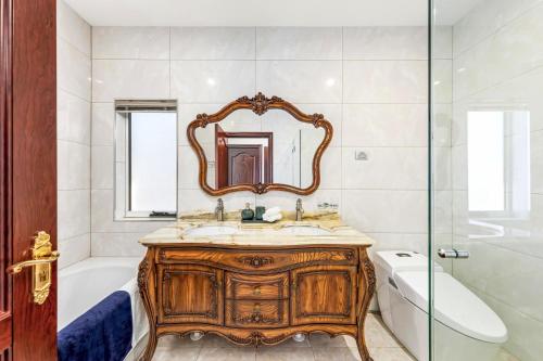 a bathroom with a wooden vanity and a mirror at Private Rm in a Stylish Chatswood Home Near Station in Sydney