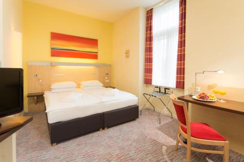 Postel nebo postele na pokoji v ubytování Exe City Park Hotel