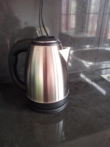 a tea kettle sitting on a counter next to a window at Menik's place in Mirissa
