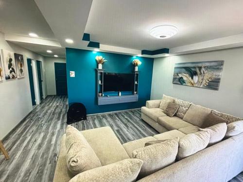 a living room with a couch and a tv at Tobago Tropical Hideaway in Lowlands