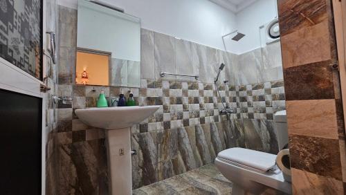 a bathroom with a sink and a toilet at Three Elements Mirissa in Mirissa