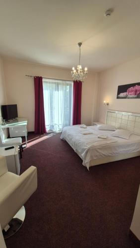 a bedroom with two beds and a desk and a bed sidx sidx sidx at Hotel Imperial Timisoara by JR in Timişoara