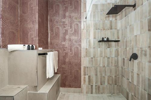 a bathroom with a shower with a tub and a sink at Table Mountain Views - Stylish Gardens Apartment in Cape Town