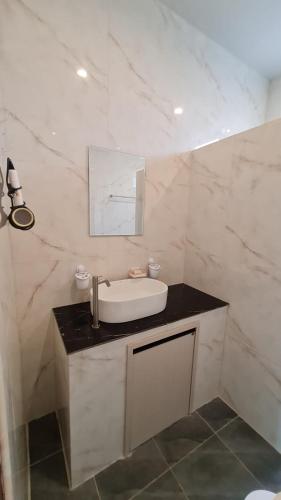 a white bathroom with a sink and a mirror at Samati Hill - Sunset Pool Villa 7 - Klong Ning Beach in Ko Lanta Yai