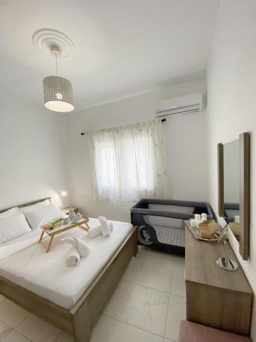 a bedroom with two beds and a table in it at Sadin apartment in Neos Marmaras