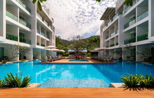 a swimming pool in the middle of a building at The Old Phuket - Karon Beach Resort in Karon Beach