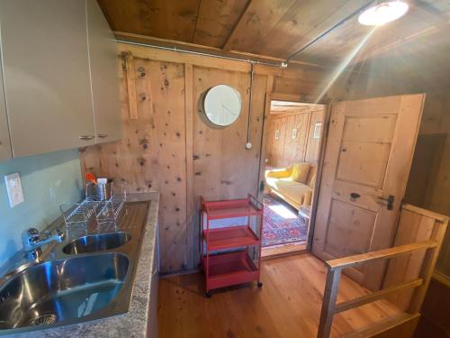 a tiny house with a sink and a kitchen at Arvenstube - Wergenstein in Wergenstein