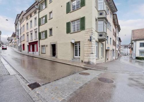 an empty street with a building on the side of it at The R Apartment Hemmental in Schaffhausen