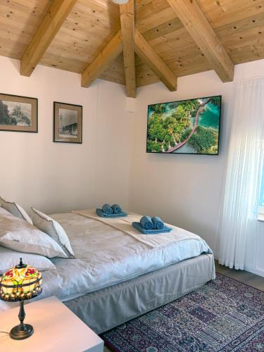 a bedroom with a bed with two blue towels on it at Casa Rinata in Novigrad Istria