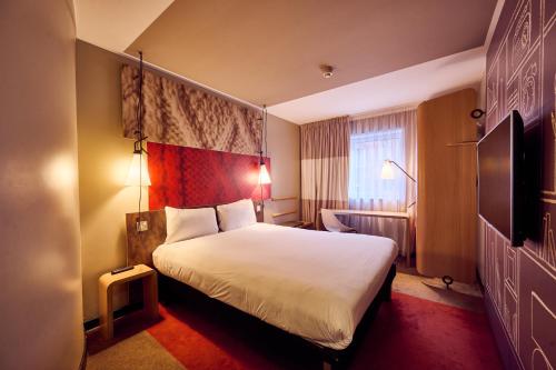 a hotel room with a bed and a television at a&o Manchester City Centre in Manchester