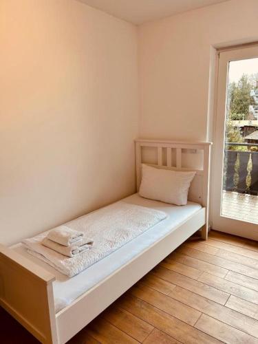 a small bed in a room with a window at Huus 17 in Rust