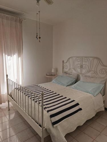 a bedroom with a large bed with blue pillows at Su Planu in Cagliari